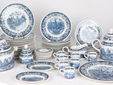 many blue and white plates and cups and saucers