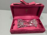 a pink box that has a glass bow in it