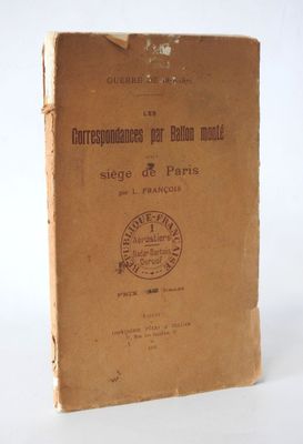 an old book sitting on top of a table on a white surface