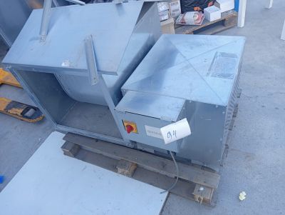 a metal box sitting on top of a pallet in a warehouse
