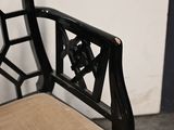 a black chair with a tan seat and a brown cushion