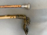 two old walking canes that are on a table