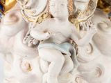 a figurine of a child sitting on a cloud