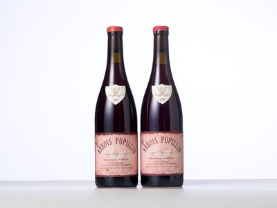 two bottles of wine sitting on top of a table