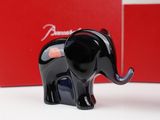 a black elephant figurine sitting next to a red box