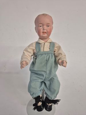 a small doll that is sitting on top of a ball