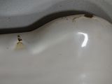 a white sink with a black handle in a bathroom