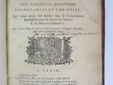 an old book with writing on it sitting on a table