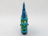 a close up of a glass vase on a white surface
