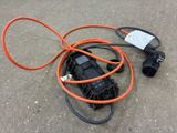 an orange and black electrical cord connected to a black and white electrical plug