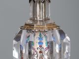 a glass vase with a gold and blue decoration on it