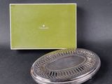 a silver plate with a green box in the background