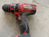 a cordless drill that is laying on the ground