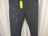 Le pantalon est noir et porte une étiquette verte.