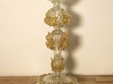 a glass candle holder sitting on a wooden table