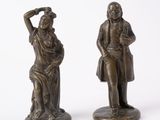 pair of antique bronze figurines of a man and a woman