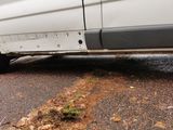 a white van that is parked on the side of the road