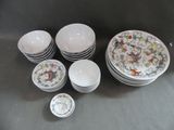 a lot of plates and bowls sitting on a table