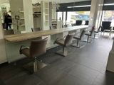 an image of a hair salon with chairs and a counter