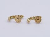 a pair of gold cufflinks with emerald stones