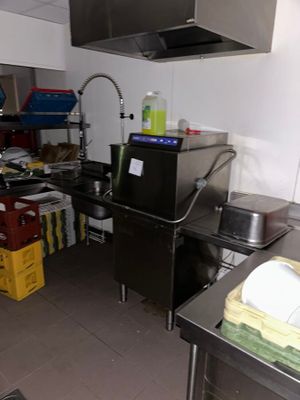a kitchen with a sink, stove, and other items in it