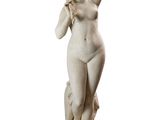 statue of a woman holding a flower in her right hand