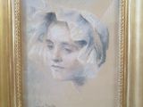 an oil painting of a woman ' s face in a gold frame