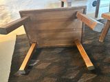 a wooden chair that is sitting on a rug