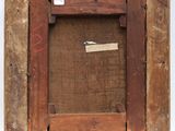 an old wooden picture frame with a tag on it