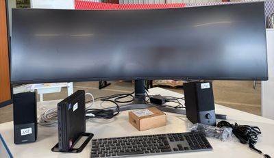 an image of a computer desk with a monitor, keyboard and mouse