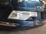 a close up of a car ' s headlight and front bumper