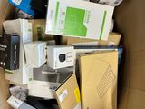 a cardboard box full of electronic devices and other items