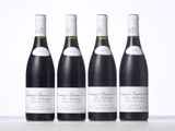 three bottles of wine are lined up on a table