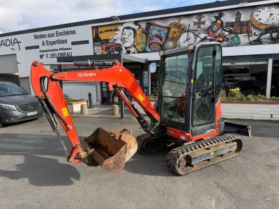 a small excavator that is parked in front of a building