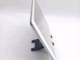 a white tablet computer sitting on top of a white table