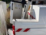 a white truck with a ladder in the back of it