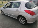 a silver car that is parked on the side of the road