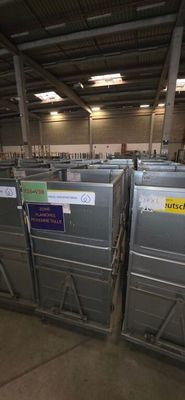many metal bins in a warehouse with labels on them