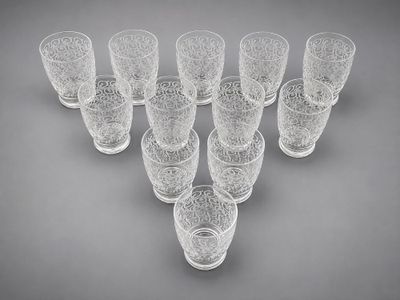 six clear glasses are arranged in a triangle on a gray background