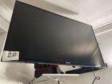 a flat screen tv hanging on a wall in a room