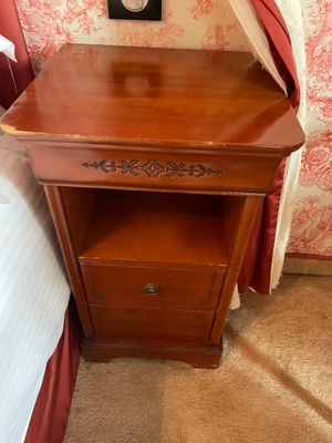 a small wooden table with a clock on top of it