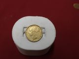 a gold coin sitting on top of a white box
