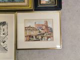three framed pictures of buildings and a staircase in a room