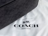 a coach bag on a white sheet with a coach logo on it
