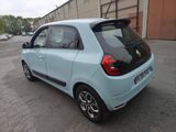 a small blue car parked in a parking lot