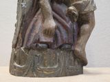 a statue of a woman sitting on a rock