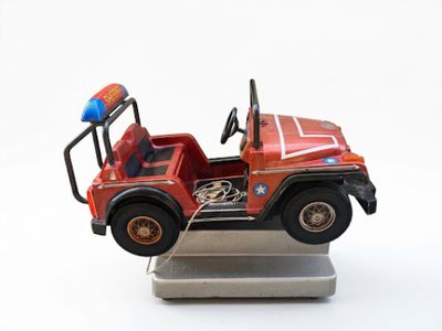 a toy fire truck that is sitting on a stand