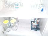 a shelf that has a bunch of glasses on top of it