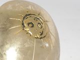 a gold ball with a face on it