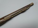 an old wooden baseball bat with a wooden handle on a white surface